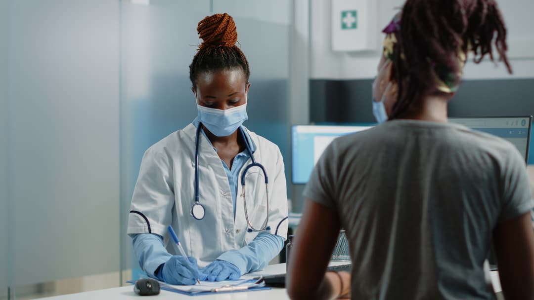 nurse writing on a document
